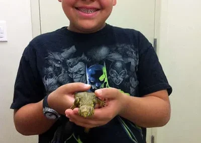 Boy holding small lizard