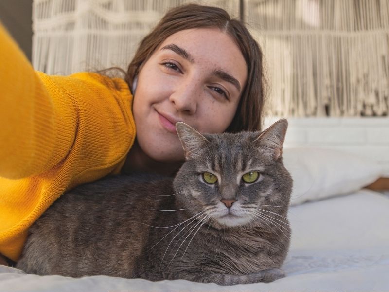 Woman takes selfie with cat